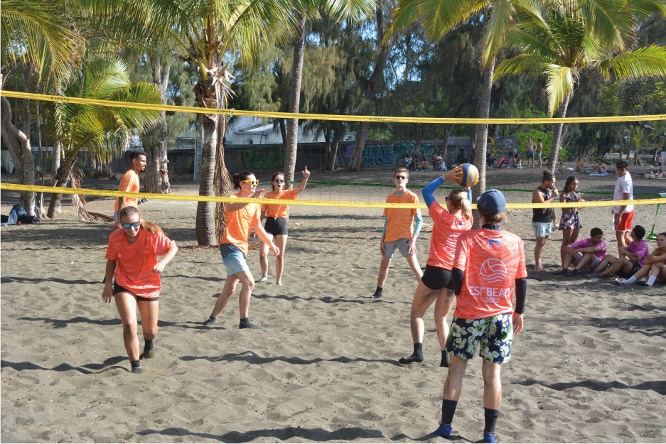 photo of high school students playing beach volleyball