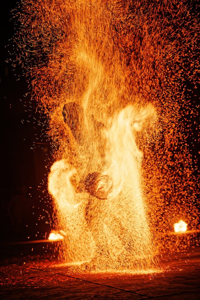 Photo of the pyrotechnics show on the Moufia campus, a man among the sparks.