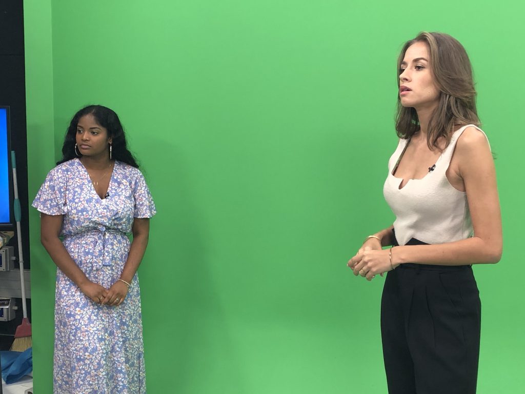 Lalita and the weather presenter meeting 1st in front of the green screen